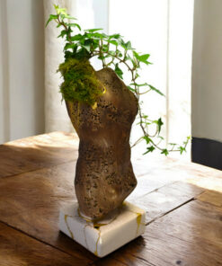 Alternative view of Male torso sculpture with kintsugi and living plants