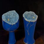 Two cobalt blue ceramic vases topped with blue geode crystals and gold crack lines.