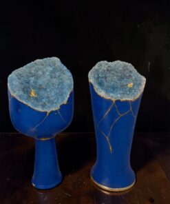 Two cobalt blue ceramic vases topped with blue geode crystals and gold crack lines.
