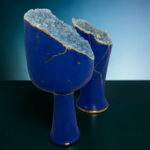 Blue ceramic vase with a jagged, crystal-like blue geode centerpiece and gold veins along the edge.