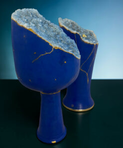 Blue ceramic vase with a jagged, crystal-like blue geode centerpiece and gold veins along the edge.
