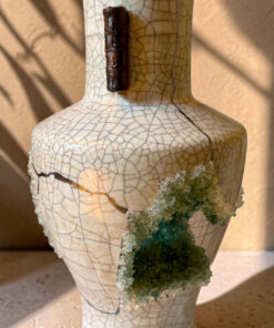 Decorative crackle-glaze ceramic vase with a dark brown neck accent and a green crystal cluster attached to its side.
