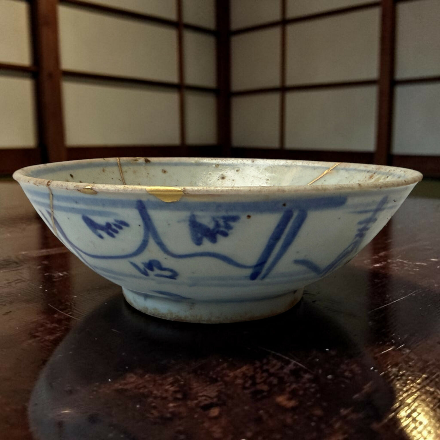 Blue and white ceramic bowl on a dark wooden table, photographed from the side.