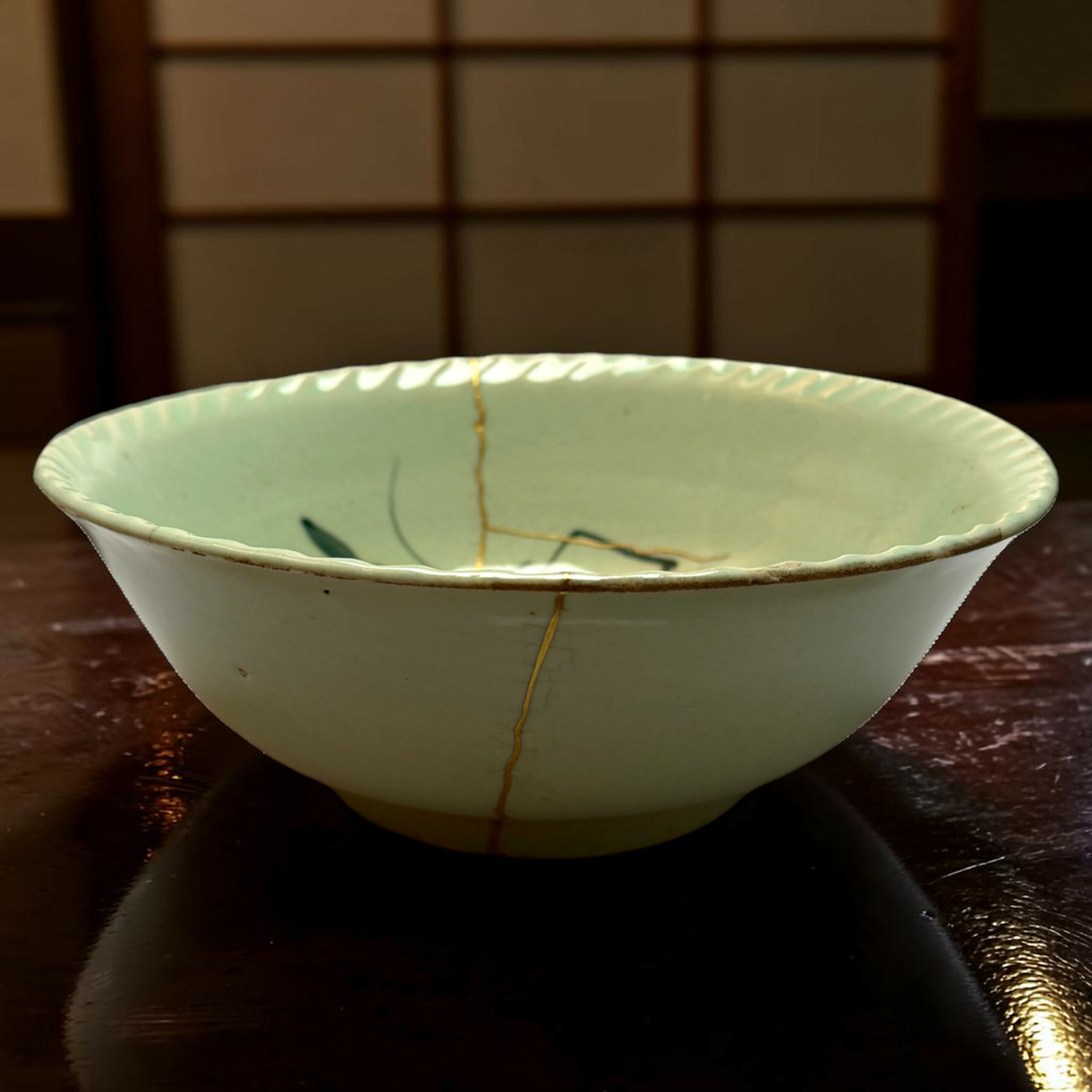 White ceramic bowl with a visible hairline crack running from top to bottom, set on a dark wooden table with a blurred grid background behind it.