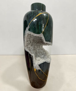 Dark green ceramic vase with gold veins and a jagged cluster of crystals along its surface.